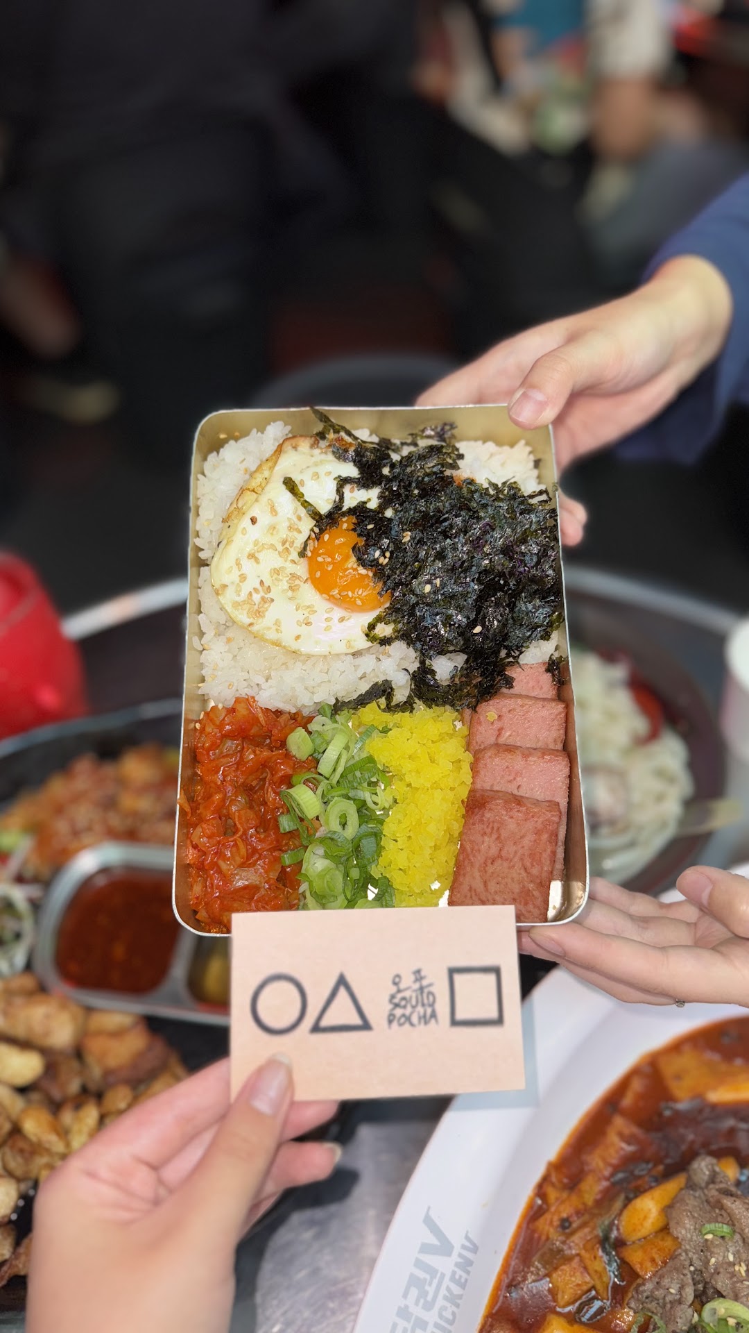 Squid Game lunch box with rice, egg, and kimchi