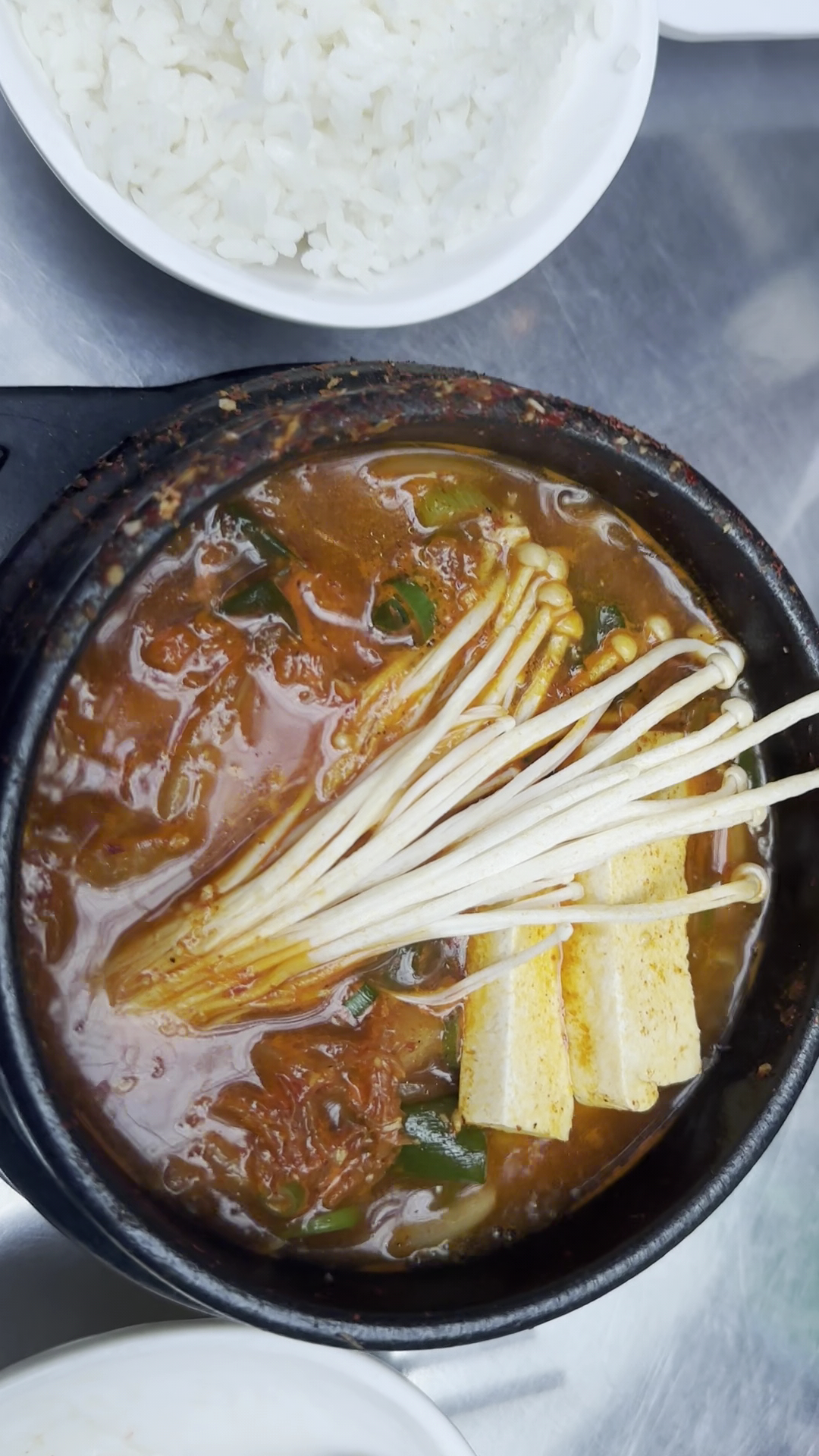 Steaming Korean hot pot served with rice