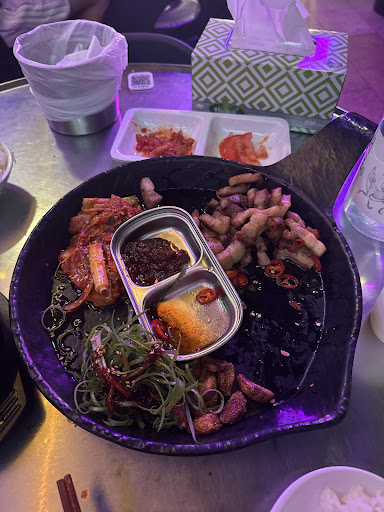 Generous Korean sharing platter under neon lights